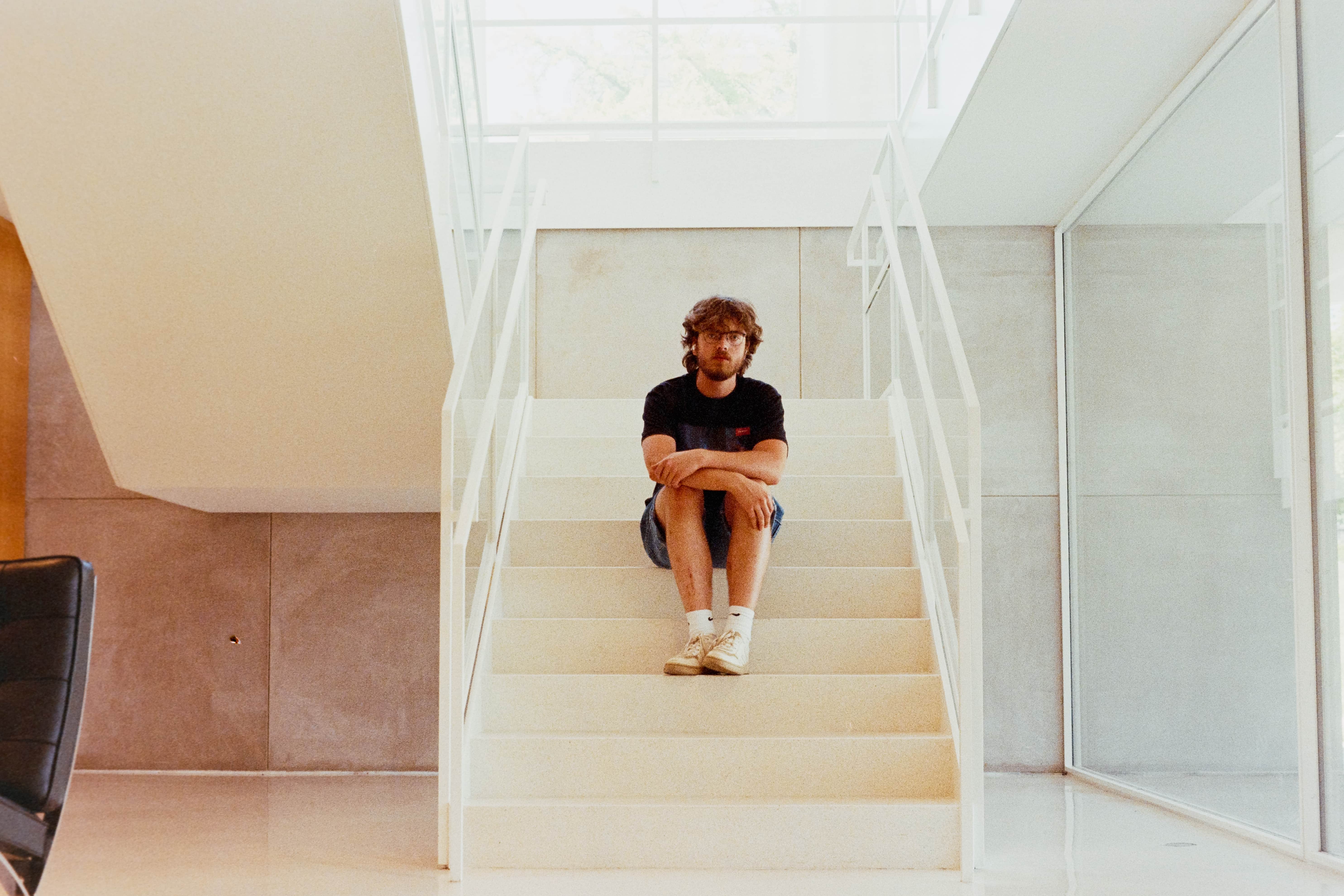 Nathan sits on the steps